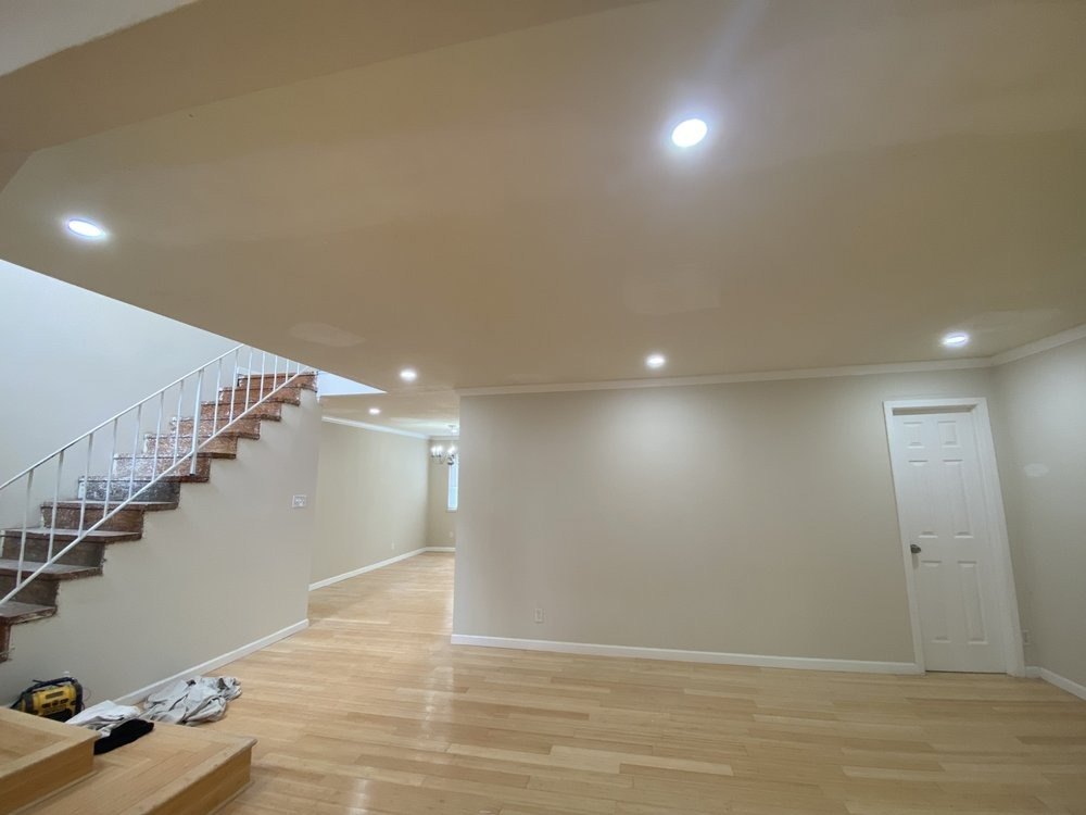Open room with new hardwood floors and a staircase