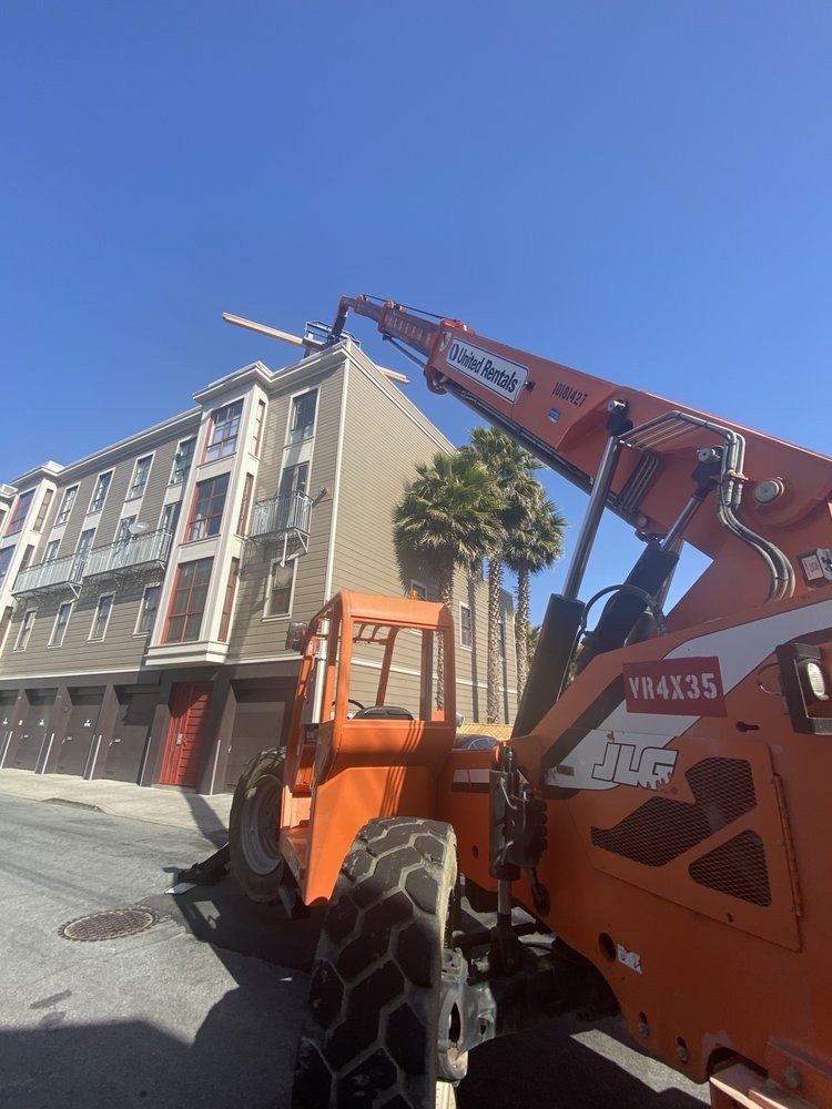 Telehandler on a San Francisco street beside a multi-story building